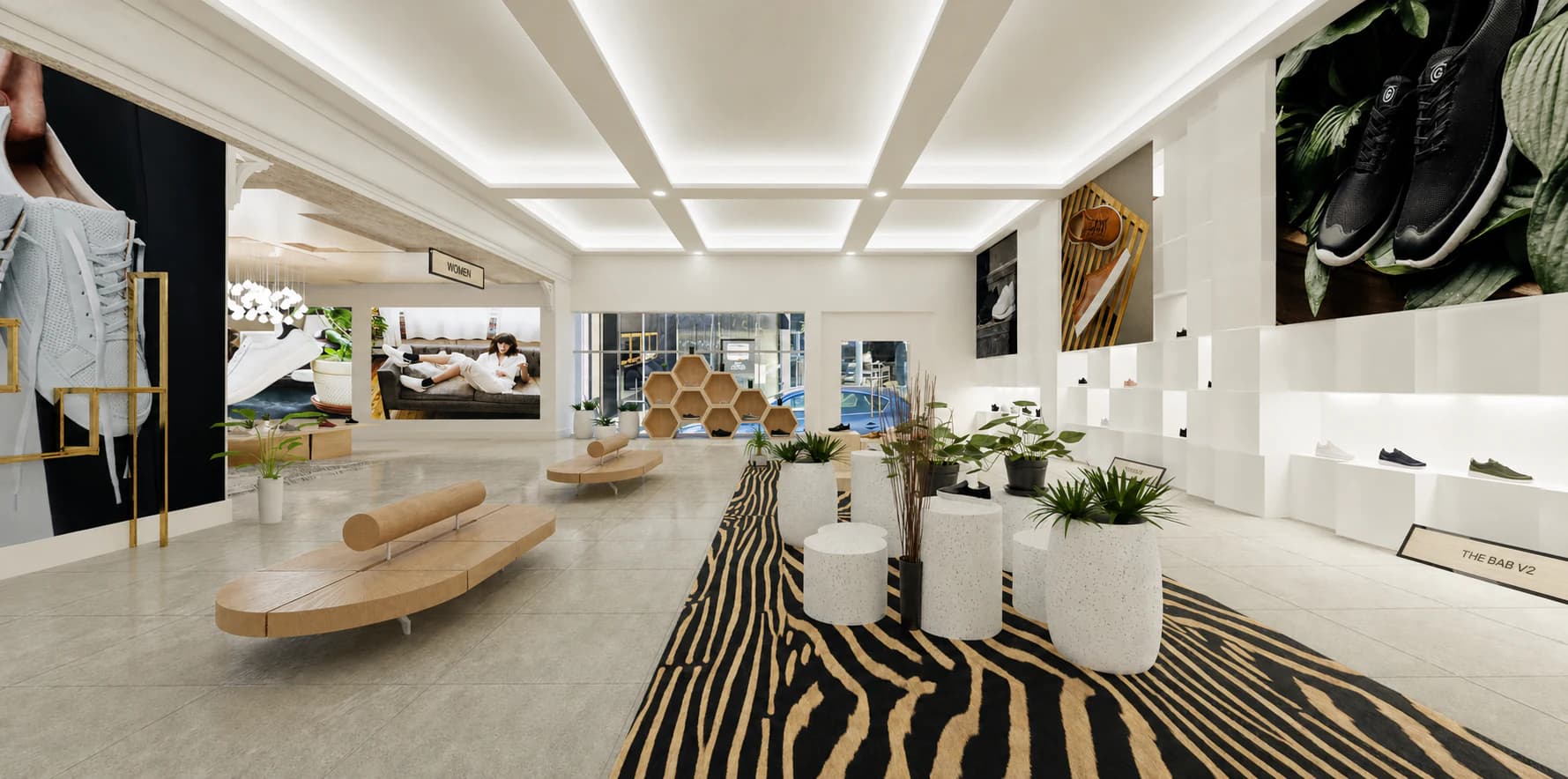 Greats store interior with wood seating, plants, modular displays, and a zebra-patterned rug.