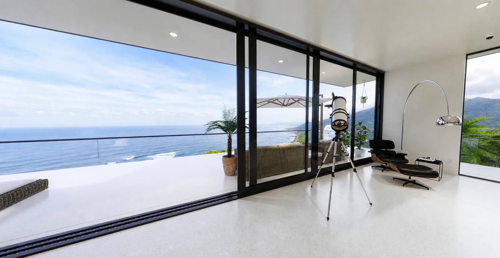 Virtual oceanfront interior with floor-to-ceiling glass, a telescope, and lounge seating.
