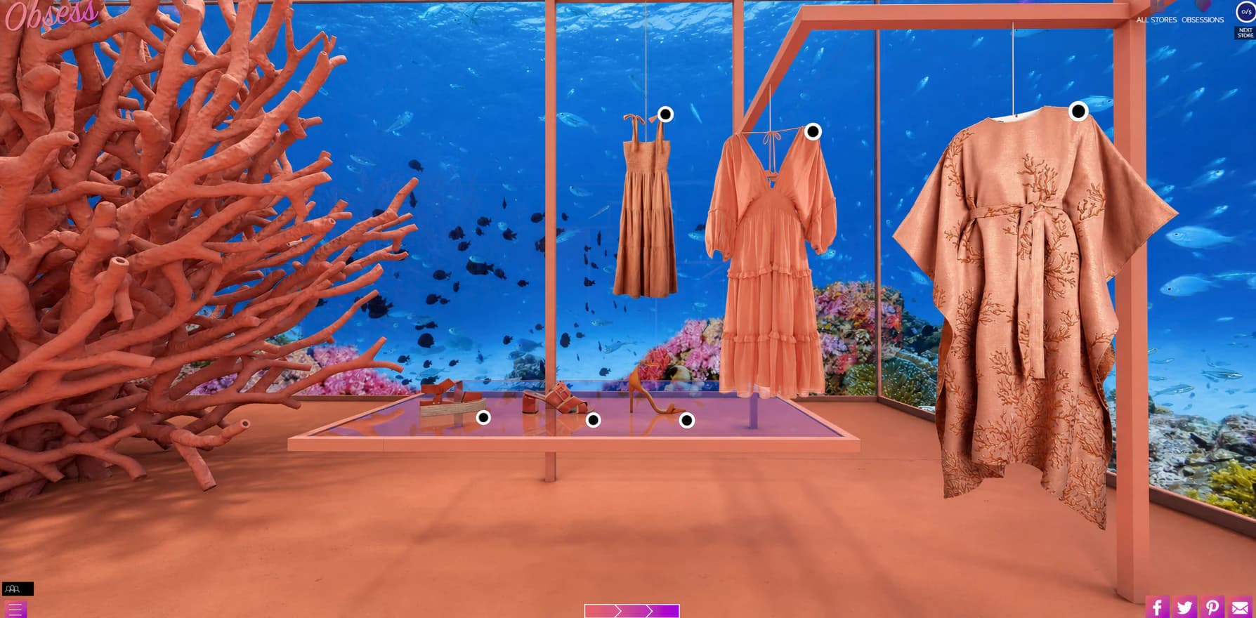 Accessories and dresses arranged beside a large coral sculpture in the underwater boutique.